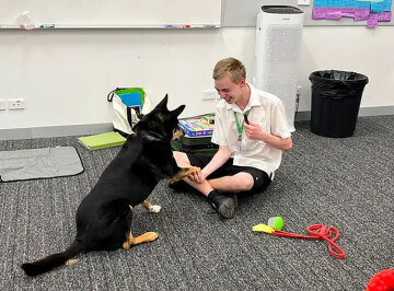 Student with a therapy dog in a classroom
